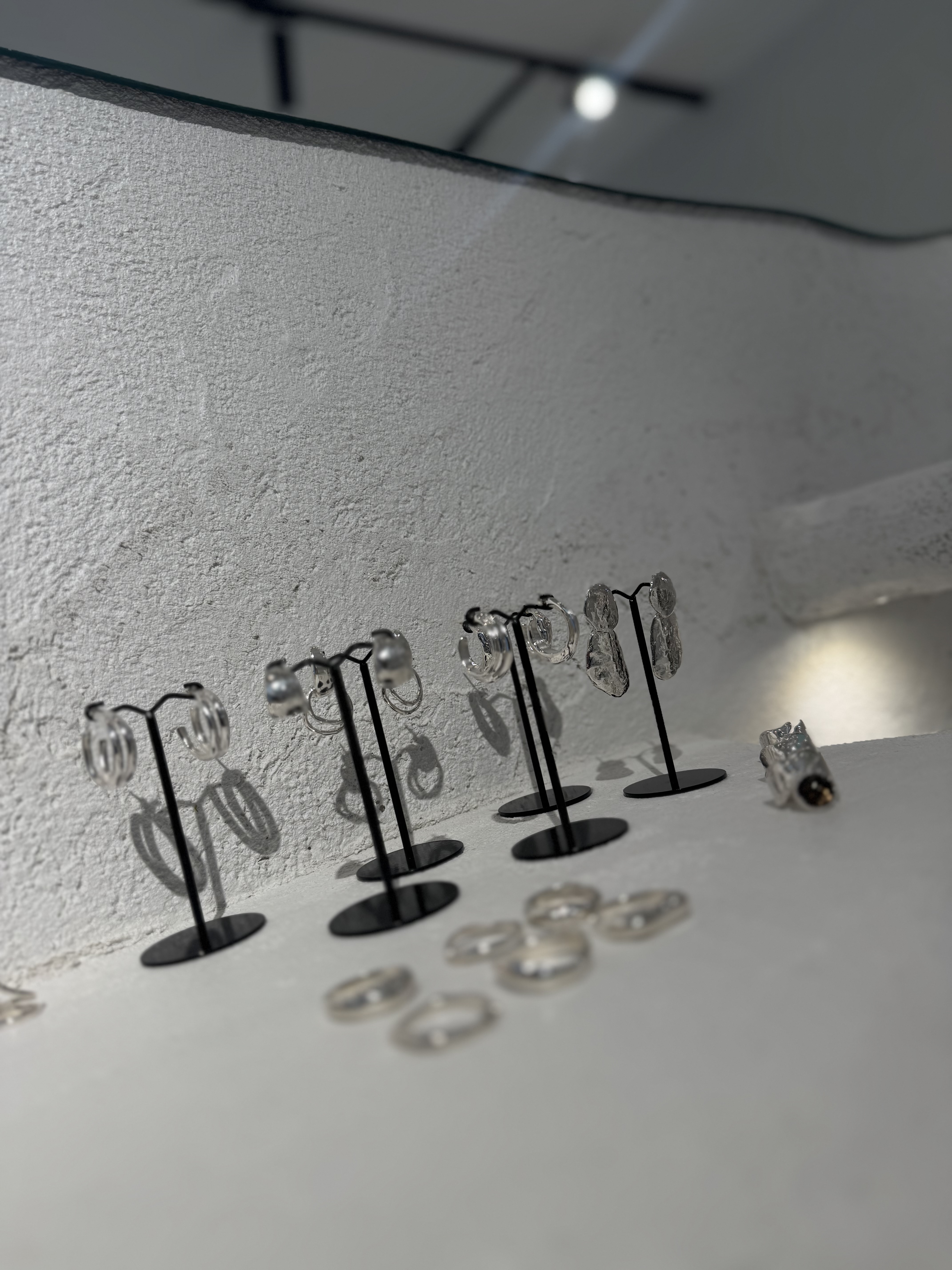 Earrings on concrete shelf